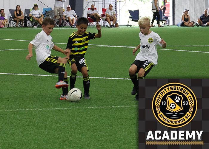 Boys Riverhounds Development Academy soccer team playing a game at the AHN Montour Sports Complex with the RDA logo in the bottom right.