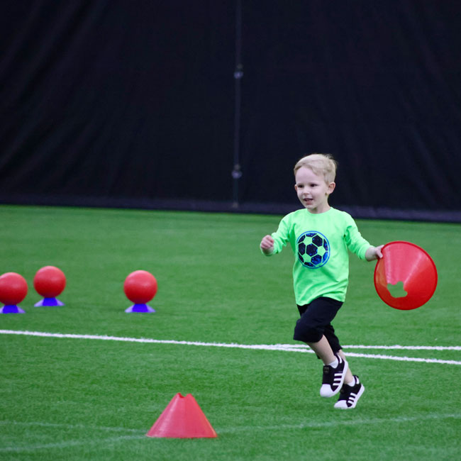 Pre School kids sports program, kid moving cones at AHN Sports Complex